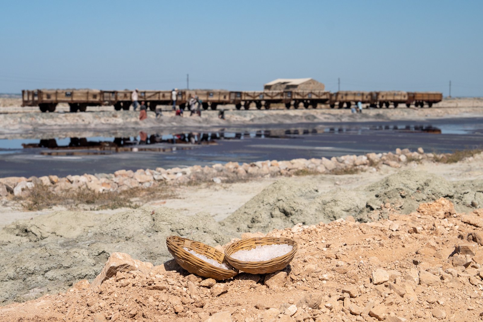 A hand reaching into a bowl of Puresol salt during the daily act of cooking